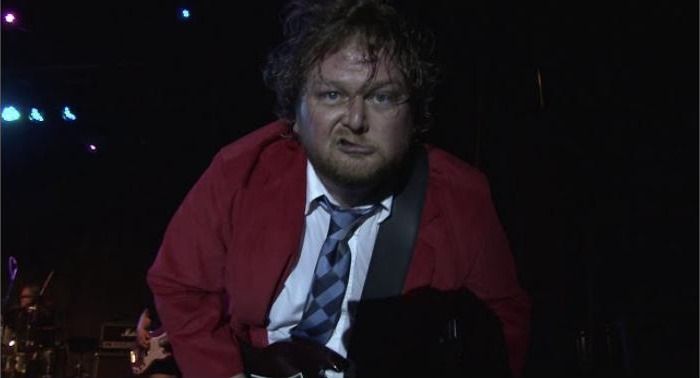 A performer on a dark stage, from Groove-V's demo reel