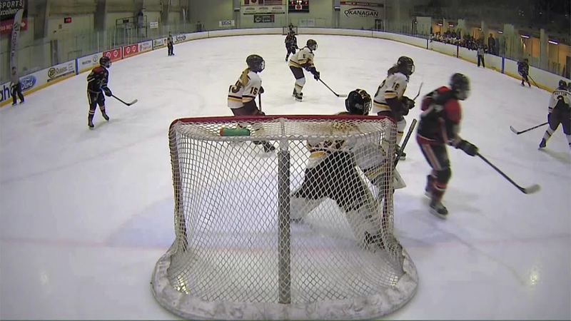 A goalie and skaters in front of the net, from the CSSHL Female Prep championship broadcast