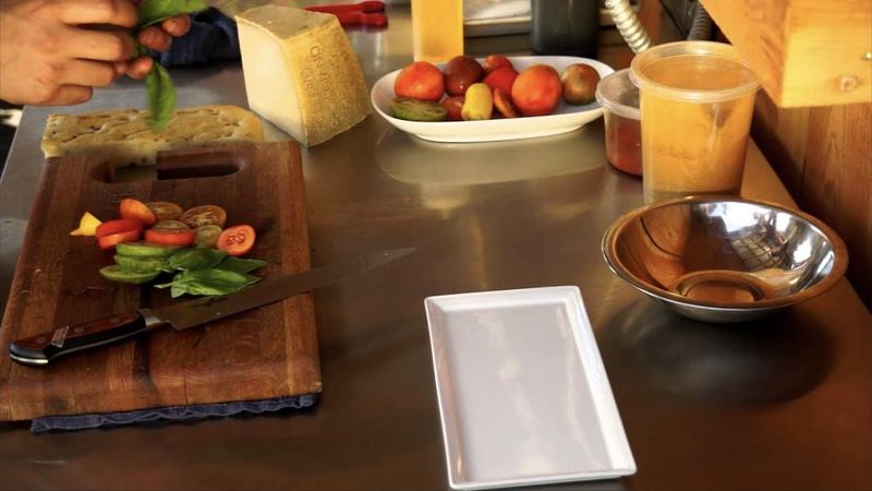 Sliced heirloom tomatoes, basil and cheese on a cutting board